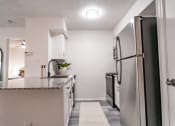 Thumbnail 11 of 37 - a kitchen with white cabinets and a black refrigerator