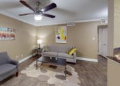 Thumbnail 1 of 19 - a living room with couches and a ceiling fan