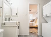 Thumbnail 7 of 37 - a small laundry room with a sink and a washer and dryer