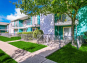 Thumbnail 17 of 18 - an apartment building with a sidewalk and trees in front of it