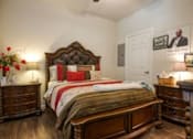 Thumbnail 6 of 9 - A bedroom with a large bed and a wooden dresser.