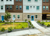 Thumbnail 24 of 27 - a sidewalk in front of an apartment building