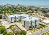 Thumbnail 25 of 27 - an aerial view of an apartment complex with a city in the background