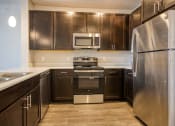 Thumbnail 5 of 27 - a kitchen with stainless steel appliances and wooden cabinets