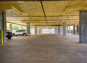 Thumbnail 16 of 27 - a parking garage with cars parked in it
