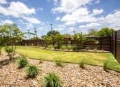 Thumbnail 10 of 27 - a backyard with a grass lawn and a fence