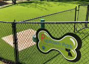 Thumbnail 21 of 23 - a park with a playground and a sign on a fence