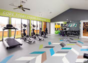 Thumbnail 7 of 18 - A gym with a variety of equipment including treadmills, exercise bikes, and weights.