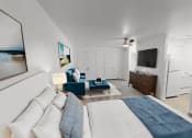 Thumbnail 4 of 16 - a bedroom with a bed and a couch and a tv