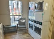 Thumbnail 18 of 22 - a laundry room with washers and dryers