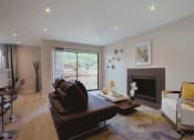 Thumbnail 4 of 20 - a living room with a leather couch and a fireplace