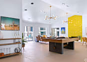 Thumbnail 9 of 16 - a living room with a pool table and a dining room in the background