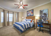 Thumbnail 21 of 25 - the master bedroom has a large bed and a ceiling fan