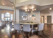 Thumbnail 17 of 25 - a dining room with a large table and chairs and a living room with couches