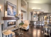 Thumbnail 18 of 25 - a living room with a fireplace and a table with chairs