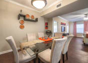 Thumbnail 19 of 25 - a dining room with a table and chairs and a window