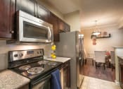 Thumbnail 8 of 25 - a kitchen with stainless steel appliances and granite counter tops