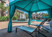 Thumbnail 13 of 25 - a gazebo with chairs and a pool with a fountain