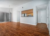 Thumbnail 13 of 35 - an empty living room with wood flooring and a glass closet