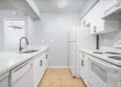 Thumbnail 10 of 35 - a white kitchen with white appliances and white cabinets