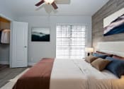 Thumbnail 9 of 22 - a bedroom with a large bed and a ceiling fan