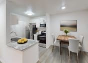 Thumbnail 6 of 23 - a kitchen and dining room with a table and chairs