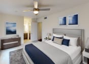 Thumbnail 10 of 23 - a bedroom with a large bed and a ceiling fan
