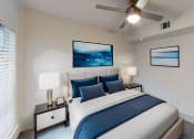Thumbnail 8 of 23 - a bedroom with a large bed and a ceiling fan