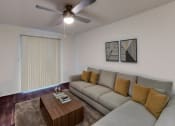 Thumbnail 4 of 23 - a living room with a couch and a coffee table
