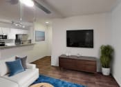 Thumbnail 12 of 23 - a living room with a white couch and a tv