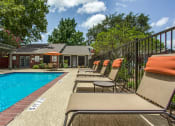Thumbnail 15 of 23 - a pool with chairs and a house in the background