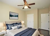 Thumbnail 2 of 8 - a bedroom with a large bed and a ceiling fan
