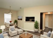 Thumbnail 3 of 8 - a living room with a couch and a table and a television