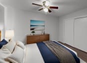Thumbnail 9 of 18 - a bedroom with a bed and a ceiling fan