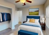 Thumbnail 3 of 18 - a bedroom with a large bed and a ceiling fan