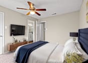Thumbnail 3 of 16 - a bedroom with a large bed and a ceiling fan