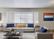 Thumbnail 4 of 18 - a living room with a couch and a coffee table and a window