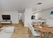 Thumbnail 1 of 18 - a living room and dining room with a table and chairs and a television