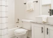 Thumbnail 17 of 37 - a white bathroom with a shower and a toilet
