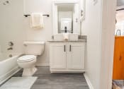Thumbnail 12 of 37 - a bathroom with a toilet and a sink and a bath tub