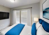 Thumbnail 8 of 20 - a bedroom with a large bed and a tv