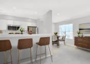 Thumbnail 3 of 20 - an open kitchen and dining area with bar stools and a table with chairs