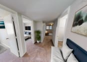Thumbnail 2 of 13 - a living room with a couch and a view of a bedroom