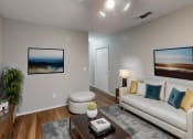 Thumbnail 2 of 20 - a living room with a couch and a coffee table