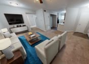 Thumbnail 5 of 13 - a living room with white furniture and a blue rug