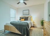 Thumbnail 10 of 37 - a bedroom with a bed and a ceiling fan