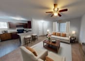 Thumbnail 6 of 13 - living room with couches and a large tv and a kitchen