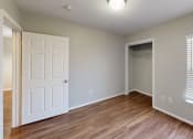 Thumbnail 13 of 20 - Bedroom with faux wood floors and a closet