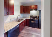 Thumbnail 4 of 20 - a kitchen with granite counter tops and black appliances