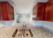 Thumbnail 11 of 20 - Kitchen sink with cabinets on each side looking into dining room